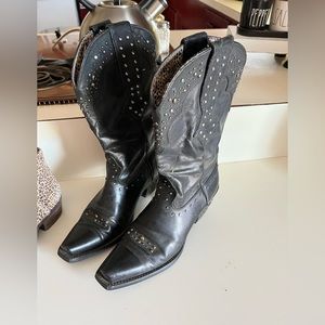 Woman’s black boots with rhinestones.